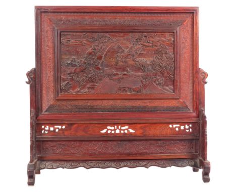 A Chinese carved Huang Huali table screen, relief carved depicting Ancient village scene with bridge and boat, W38cm, H40cm