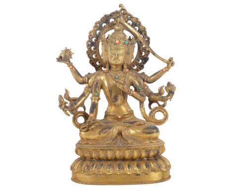 A Tibetan style bronze deity on lotus base, figure of Durga, decorated with turquoise and coral bosses, H24cmNo damage or res