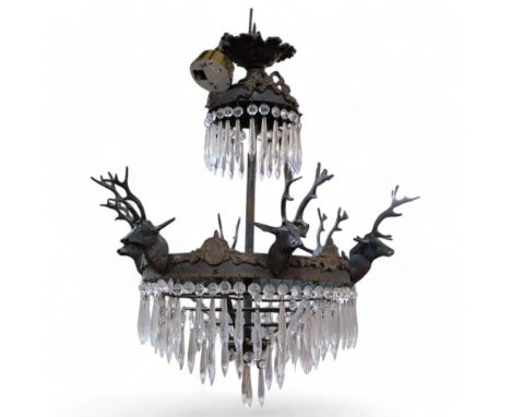 An Antique 4-tier chandelier, metal mounts supported by stags with drop glass lustres, H70cm approx