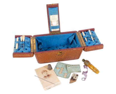 An Antique Victorian leather travelling sewing box, with triple-hinged cover opening to reveal fitted button-back interiorOve