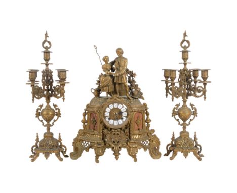 An ornate brass clock garniture, clock having white enamel lozenges with Roman numerals, 8-day striking movement surmounted b