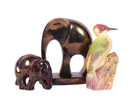 A stylised copper lustre elephant, H19.5cm, another, and a Royal Worcester woodpecker