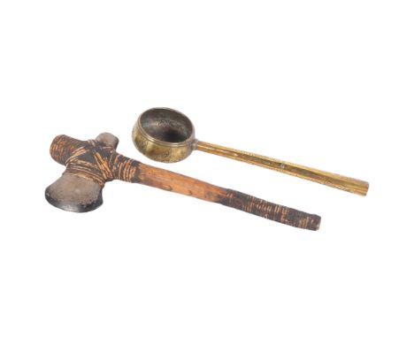 A stone and reed axe from Borneo, 39cm, and an Indian embossed brass ladle (2)
