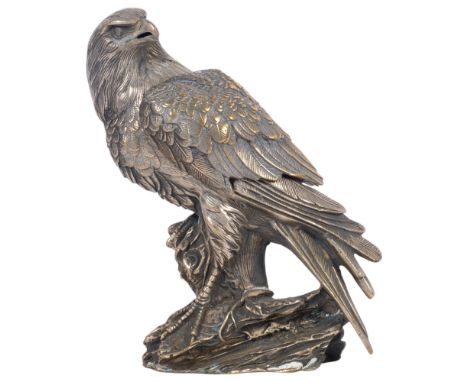 A Tibetan silvered bronze eagle on naturalistic stand, the wings lift off to reveal an inner compartment, H21.5cm, signed to 