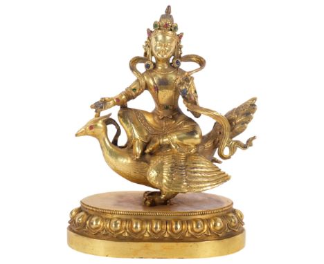 A Tibetan bronze study of Mahamayuri, H23.5cmGood overall condition,  some surface wear, it would appear not to have a great 