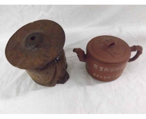 An Oriental Red Pottery Circular Teapot, the rim decorated with inscriptions; together with a further Oriental Carved Hardwoo