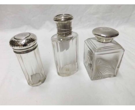 A group of three early 20th Century Silver/White metal lidded Dressing Table Jars including square example with engine turned