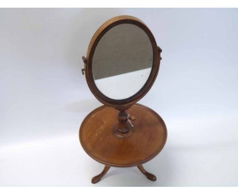 Mahogany table top Shaving Mirror, oval mirror raised on adjustable support with circular shelf below raised on a tripod base