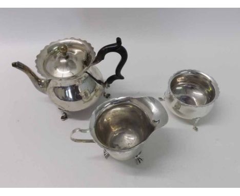 Early 20th Century matched three-piece tea set of circular baluster form, each items supported on three pad feet, comprising 