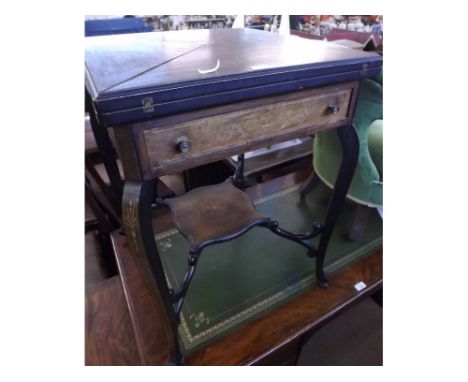 An Edwardian Mahogany Envelope Card Table with four section folding top, inlaid with panels of floral marquetry and boxwood s