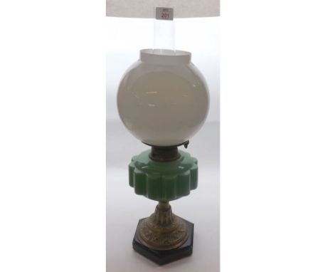 A Victorian Oil Lamp, green font over a gilded support terminating in a black base, 22" high 