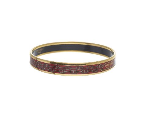 Hermes, a Chaine d'Ancre bangle bracelet, featuring a chain link printed pattern on red enamel and gold-plated edging, signed