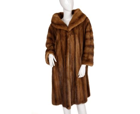 A demi buff mink fur coat, featuring a wide lapel collar, single hook and eye fastening at the neck, cocktail cuffs, two oute
