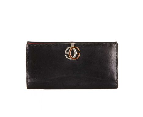 Gucci, a vintage leather wallet, designed with a smooth black leather exterior, featuring a coin compartment to one side and 