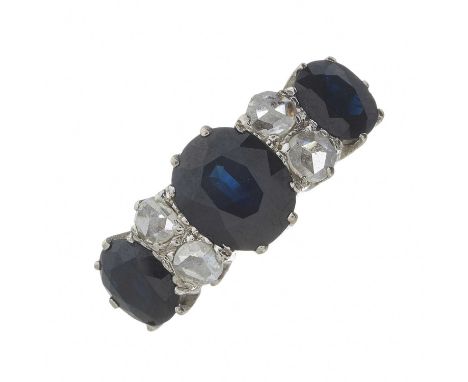 A mid 20th century 18ct gold sapphire three-stone ring, with rose-cut diamond double spacers, principal sapphire estimated we