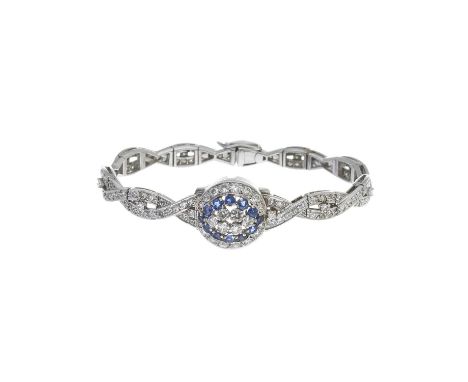 A mid 20th century platinum circular-cut diamond bracelet, with transitional-cut diamond and sapphire central hinged dome, es