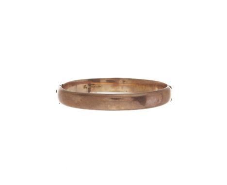 An early 20th century 9ct gold hinged bangle bracelet, hallmarks for Birmingham 1916, inner length 6.2cm, 10.7gOverall good c