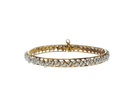 An 18ct gold seed pearl bangle bracelet, with pin clasp, inner diameter 6.1cm, 10.6gOverall good conditionWidth of bangle 0.6