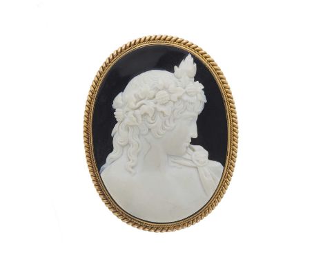 A mid 19th century carved agate cameo brooch, depicting Dionysus in profile, with cannetille surround, length 6.3cm, 67.5gOve