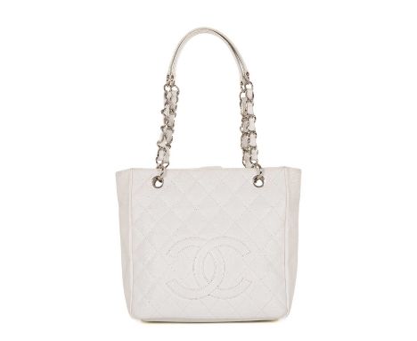 Chanel, a Petite Shopping Tote, crafted from grained white caviar leather with maker's classic diamond quilting and large emb