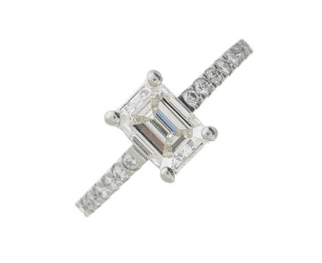 A platinum rectangular-shape diamond single-stone ring, with brilliant-cut diamond line shoulders, principal diamond estimate