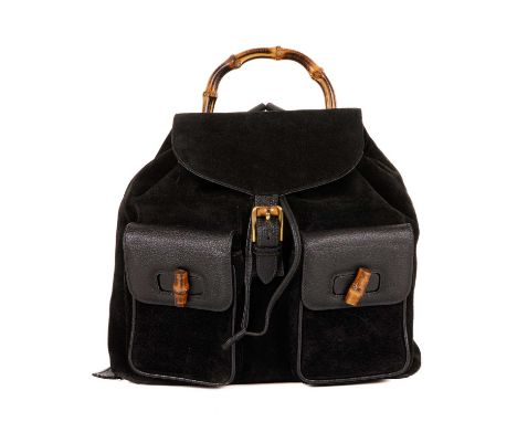 Gucci, a large Bamboo backpack, designed with a black suede exterior with grained leather trim, featuring a curved bamboo top