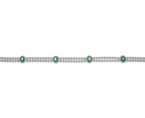 An 18ct gold brilliant-cut diamond line two-row bracelet, with oval-shape emerald spacers and push-piece clasp, estimated tot