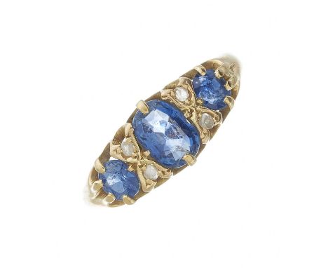 An Edwardian 18ct gold graduated sapphire three-stone dress ring, with rose-cut diamond double spacers, hallmarks for Birming