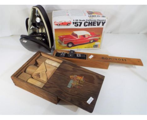 A good lot to include a vintage model kit by Revell 1:25 scale 1957 Chevy, vintage set of Dominoes in wooden case, a set of v