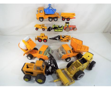 A good lot to include seven Tonka and similar vehicles in playworn condition. Also included in the lot is an unboxed Dinky To