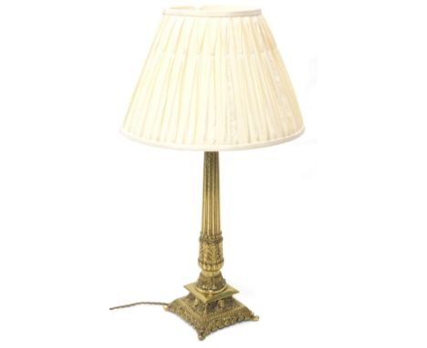 A gilt brass table lamp, with pleated shade, reeded column and square tapering base, 75cm high overall. 