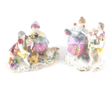 A pair of Chelsea style figure groups, the first musician and lady holding bird, polychrome decorated with gilt highlights as