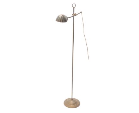 A brass standard lamp, with shell shaped shade, on a domed foot, 154cm high. 