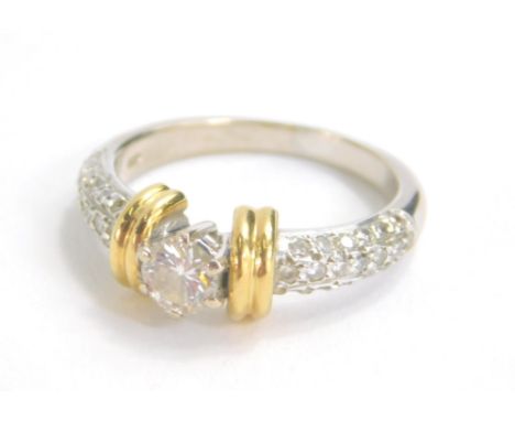 An 18ct yellow and white gold single stone diamond ring, the central stone approx. 0.45 carat, with pave set diamond shoulder