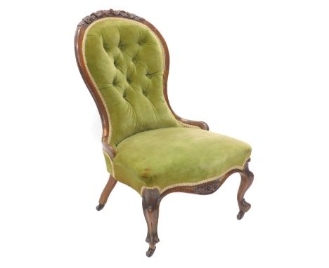 A Victorian walnut show framed spoon back nursing chair, with green upholstered padded back and seat on cabriole legs, with c