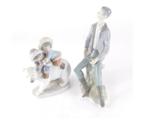 A Nao style figure of a gentleman on rock work base, and a Lladro figure group of Eskimo children riding on a polar bear, 17c