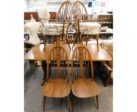 An Ercol elm rectangular dining table, with rounded corners on end supports, 74cm high, the top 83cm x 180cm, and six chairs 