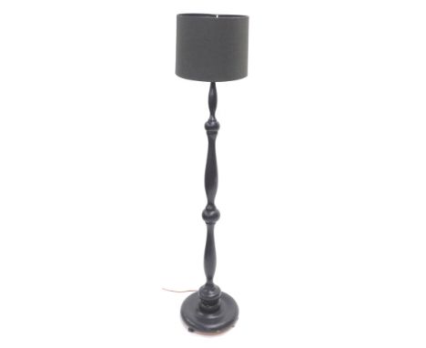 A black painted turned wooden standard lamp and shade, 159cm high.  WARNING! This lot contains untested or unsafe electrical 