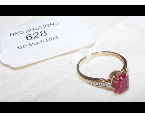 A ruby and diamond ring in 14ct gold setting 