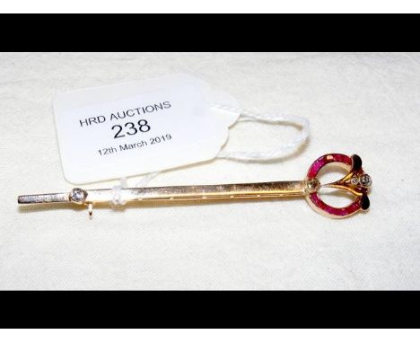 A lady's elegant diamond and ruby brooch in gold setting 