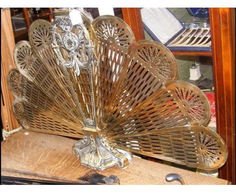 A pierced brass 'Peacock' fireguard 