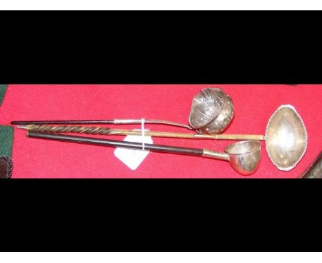 A silver toddy ladle with horn handle, together with two others 