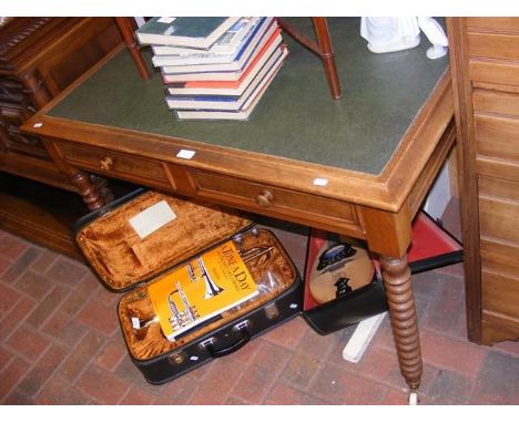 An antique two drawer desk on bobbin supports  