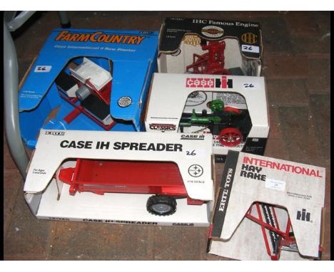 Five boxed die-cast model pieces of farm equipment, including IHC Famous Engine and other 