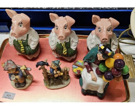 TRAY CONTAINING ROYAL DOULTON OLD BALLOON SELLER ORNAMENT, 2 HUMMEL/GOEBEL FIGURES, 3 WADE NAT WEST PIGGY BANKS   Condition