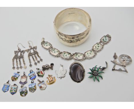 A large silver bangle maker EAA with Edinburgh hallmarks a silver enamel bracelet charms and other items Condition Report: Av
