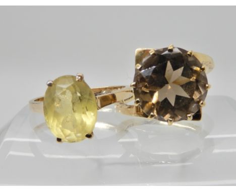 A 9ct gold retro smoky quartz ring size L1/2 and a 9ct gold citrine ring size N, weight 6.9gms Condition Report: Light genera