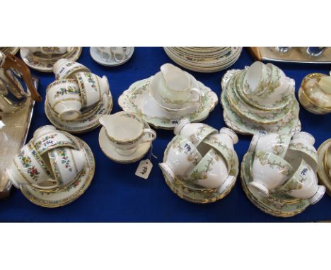 A Tuscan bone china teaset, decorated with yellow and white flowers on a green and white ground comprising; ten cups, eleven 