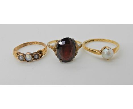 A 15ct gold pearl ring size L, weight 1.2gms, an 18ct gold pearl ring size M1/2 2gms and a 9ct gold garnet ring size N, weigh