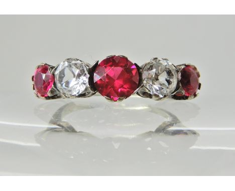 A white metal ring set with red and clear gems, finger size L1/2, weight 3.1gms Condition Report: Available upon request